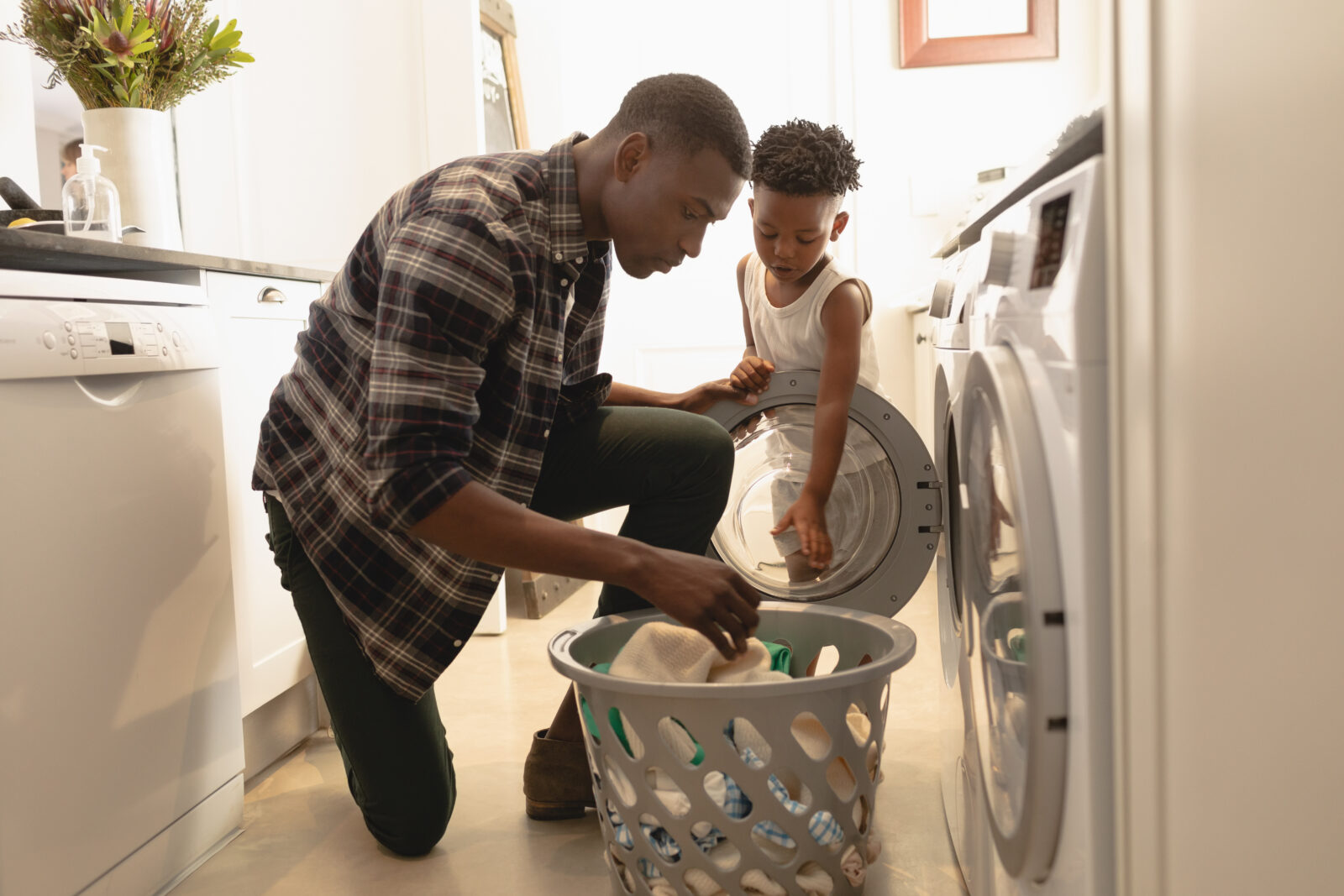 Father letting son help with laundry