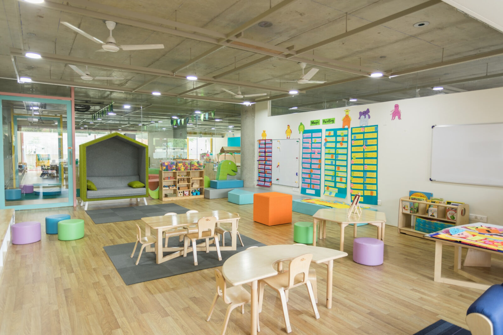 Large, brightly decorated preschool classroom
