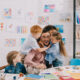 happy children hugging their teacher