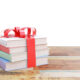 Stack of books wrapped in bright red ribbon