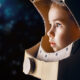 Child wearing an astronaut helmet made of cardboard