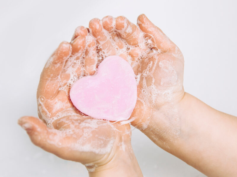 Heart shaped bar of soap lathered in a child's hands
