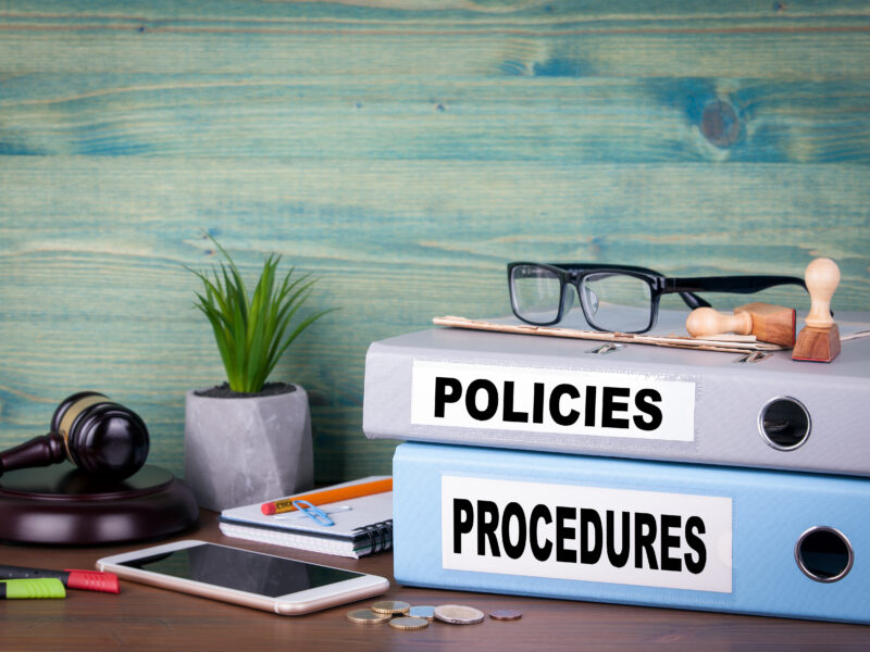 Policies and procedures handbooks on a table