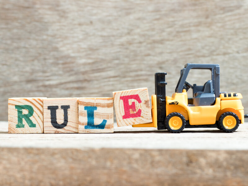 toy fork lift at the end of the word rule, lifting up the letter e