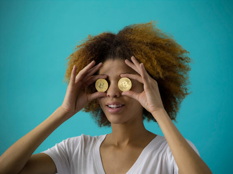 Woman holding coins to her eyes