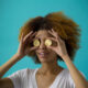 Woman holding coins to her eyes